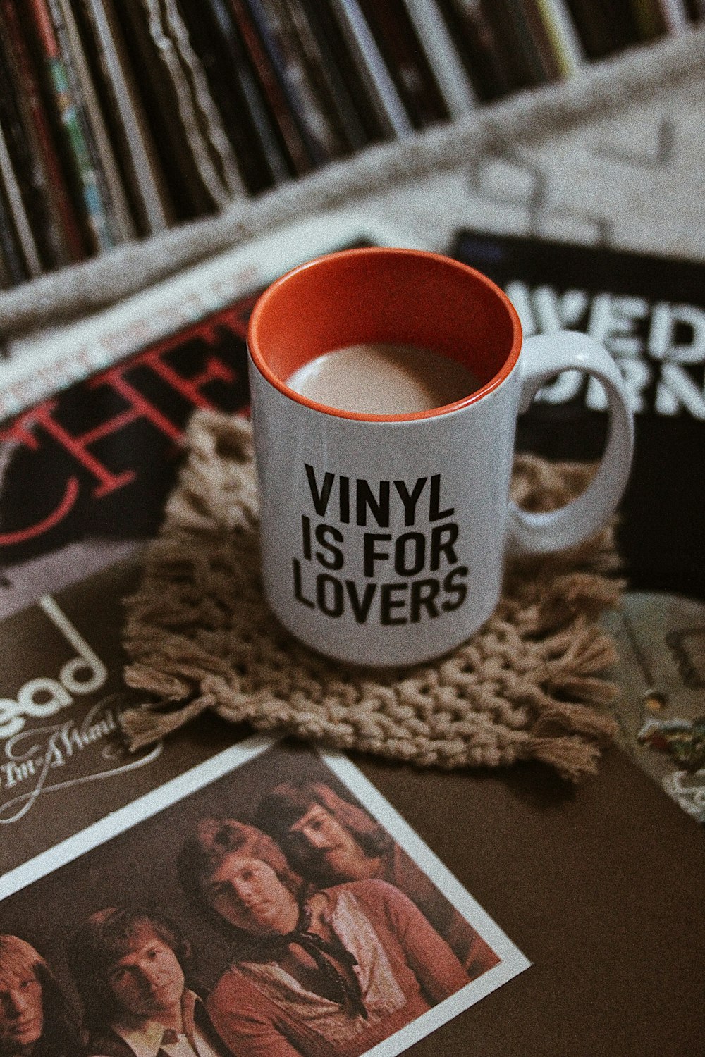 white ceramic mug on brown knit textile