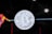 A silver Bitcoin symbol is prominently displayed against a dark background that features a geometric bull shape in vibrant colors on the left side. The background is interspersed with subtle digital patterns and flares of light that suggest a technological or futuristic theme.