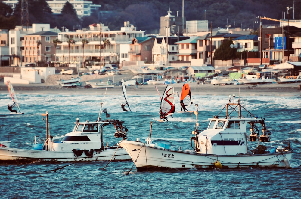 people riding on white and blue boat on body of water during daytime