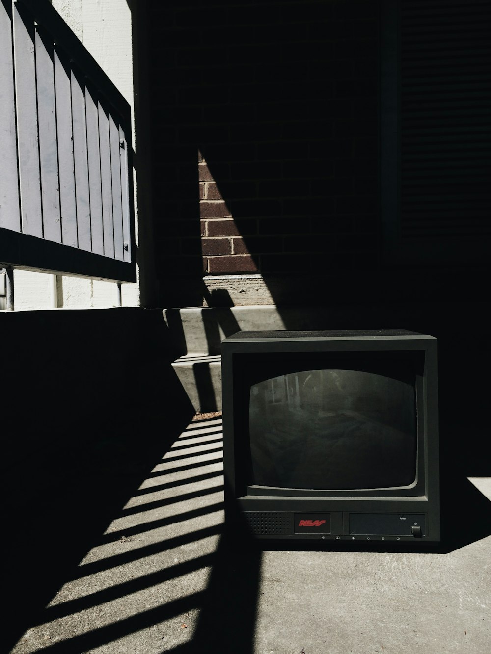 black crt tv on black wooden table