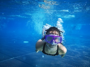 woman in white and black bikini swimming in the pool