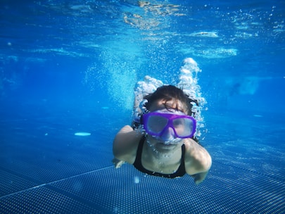 woman in white and black bikini swimming in the pool