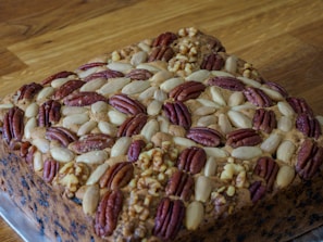Assortment of artisanal integral cakes decorated with nuts and seeds.