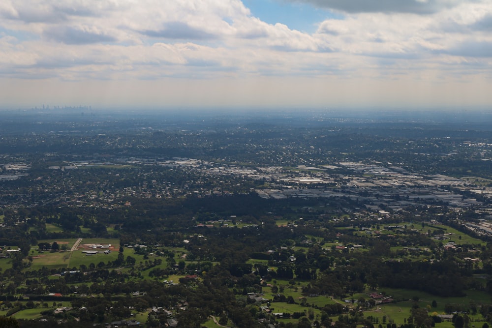 aerial view of city under cloudy sky during daytime