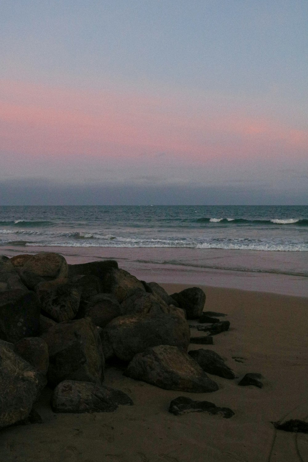 brown rocks on beach during daytime