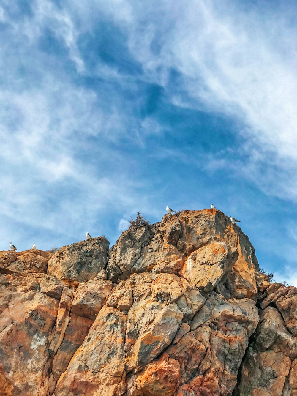 brown rocky mountain under blue sky during daytime