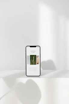 A minimalist website layout displayed on multiple devices with a clean white background.