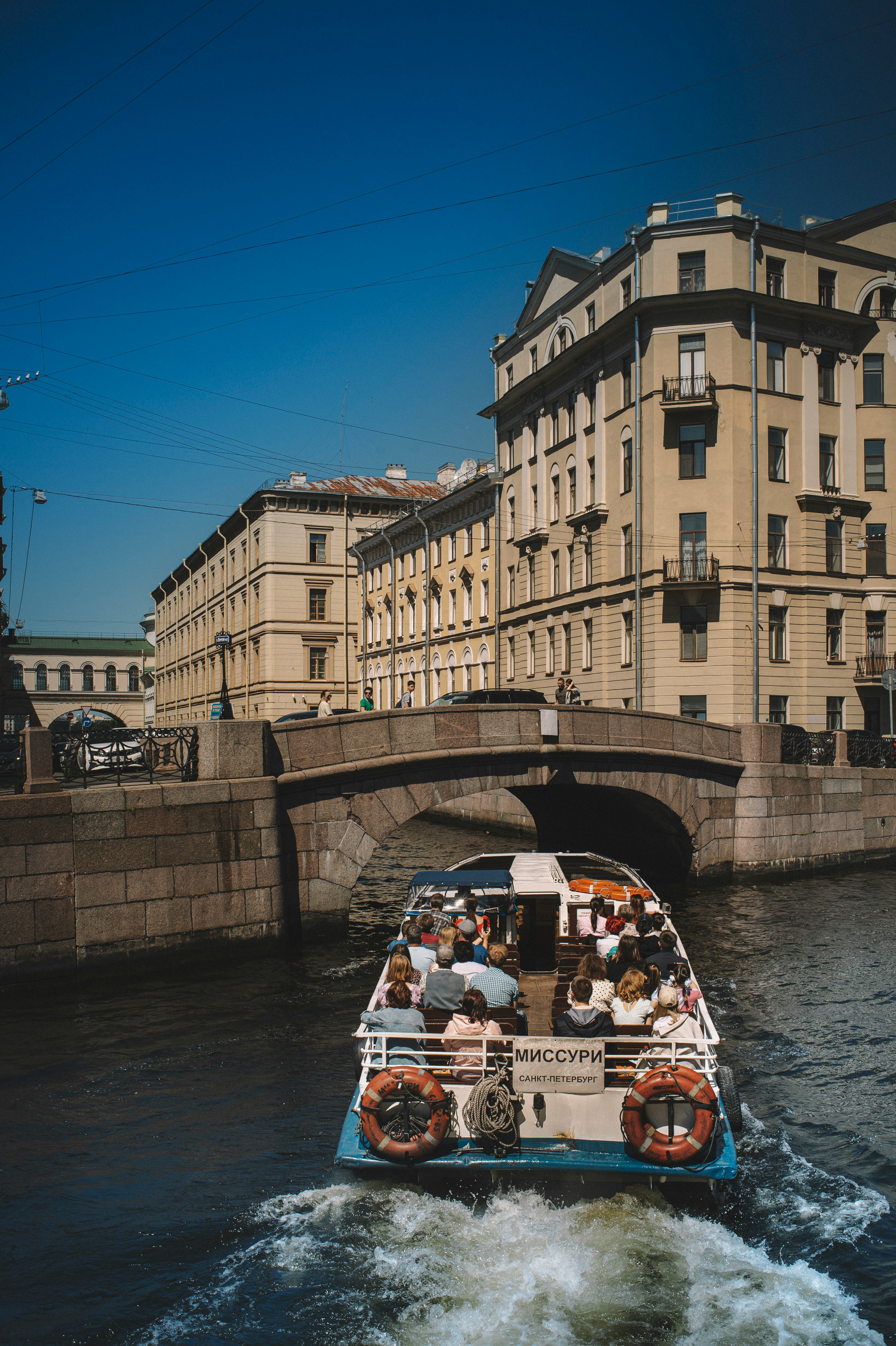 people riding on white boat on river during daytime