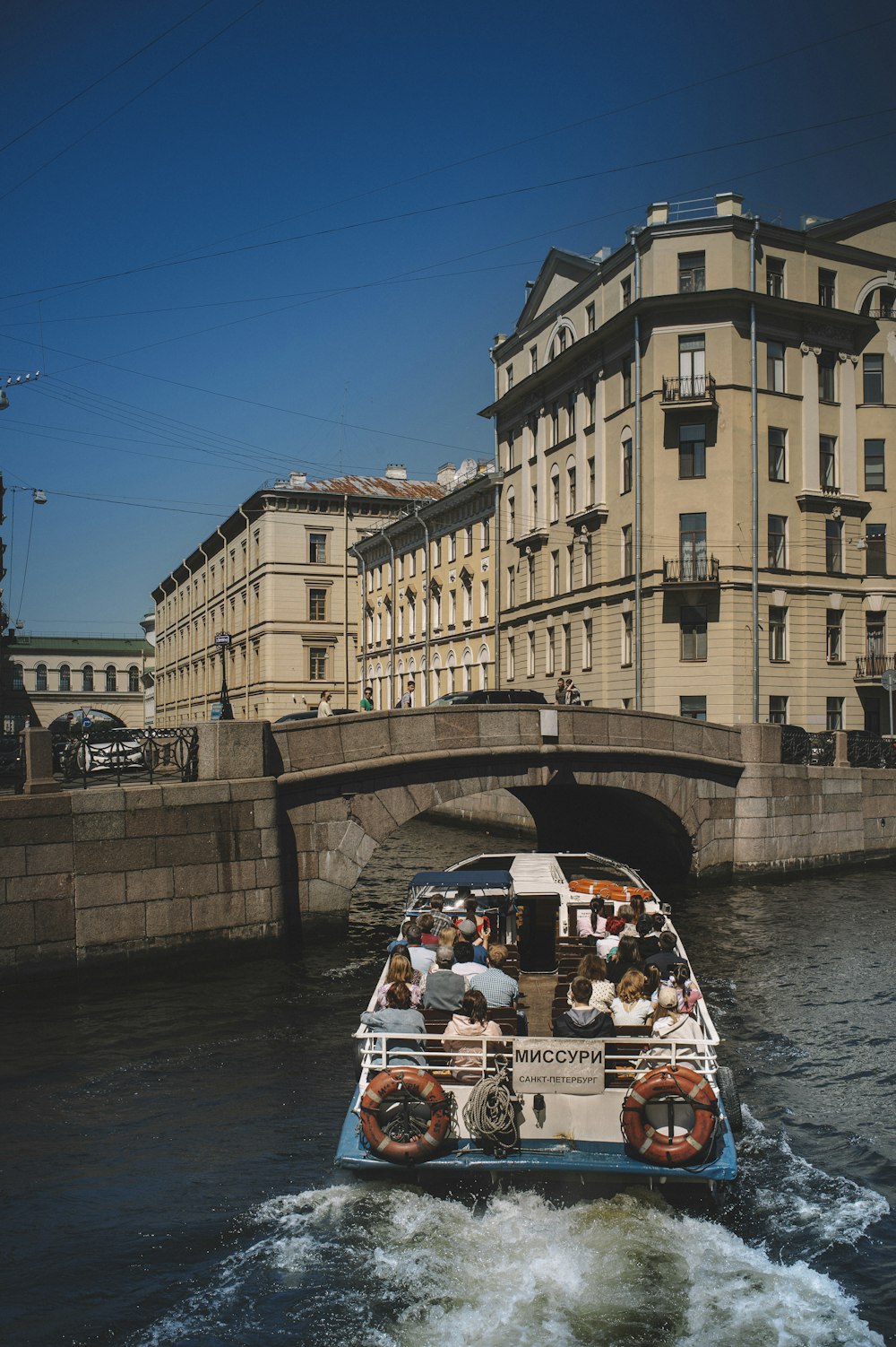 people riding on white boat on river during daytime