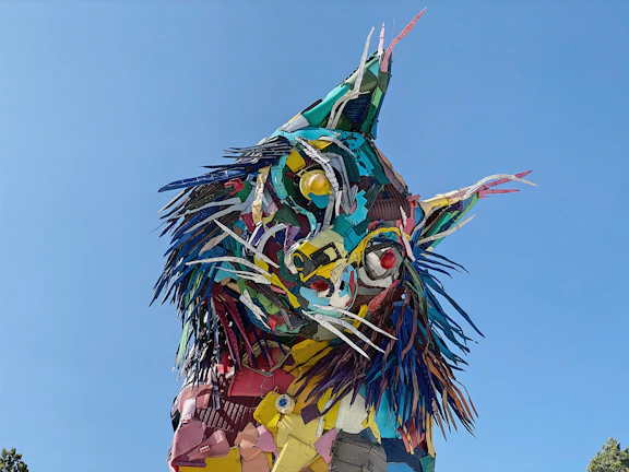 Close-up of a colorful sculpture made from recycled metal scraps.