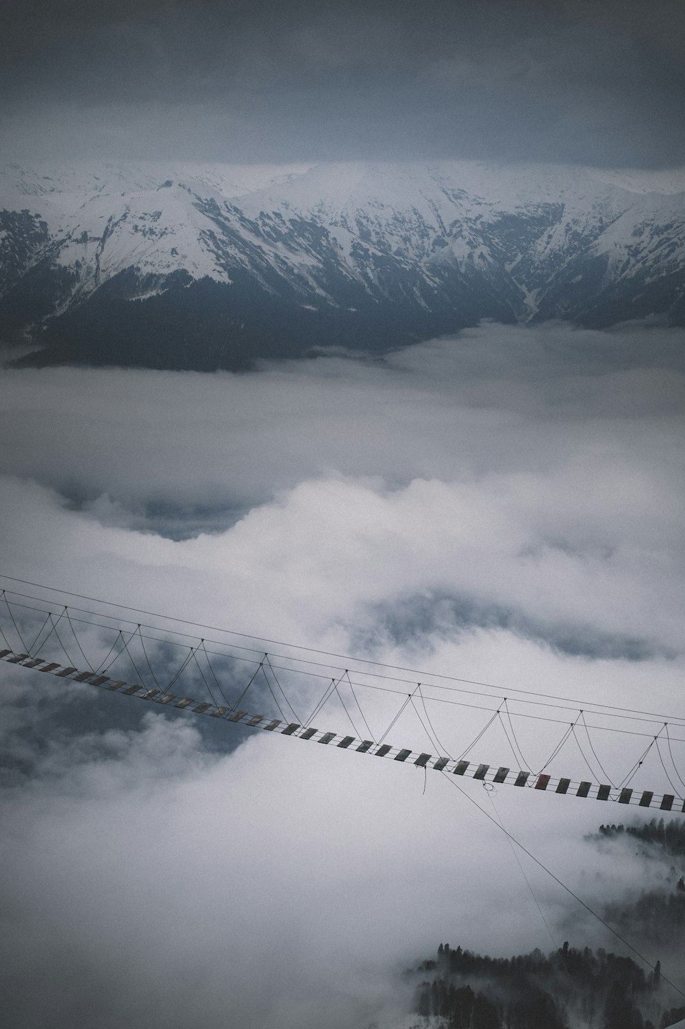 white clouds over snow covered mountain