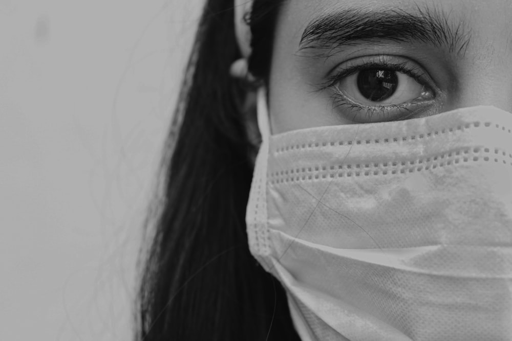 grayscale photo of woman with face mask