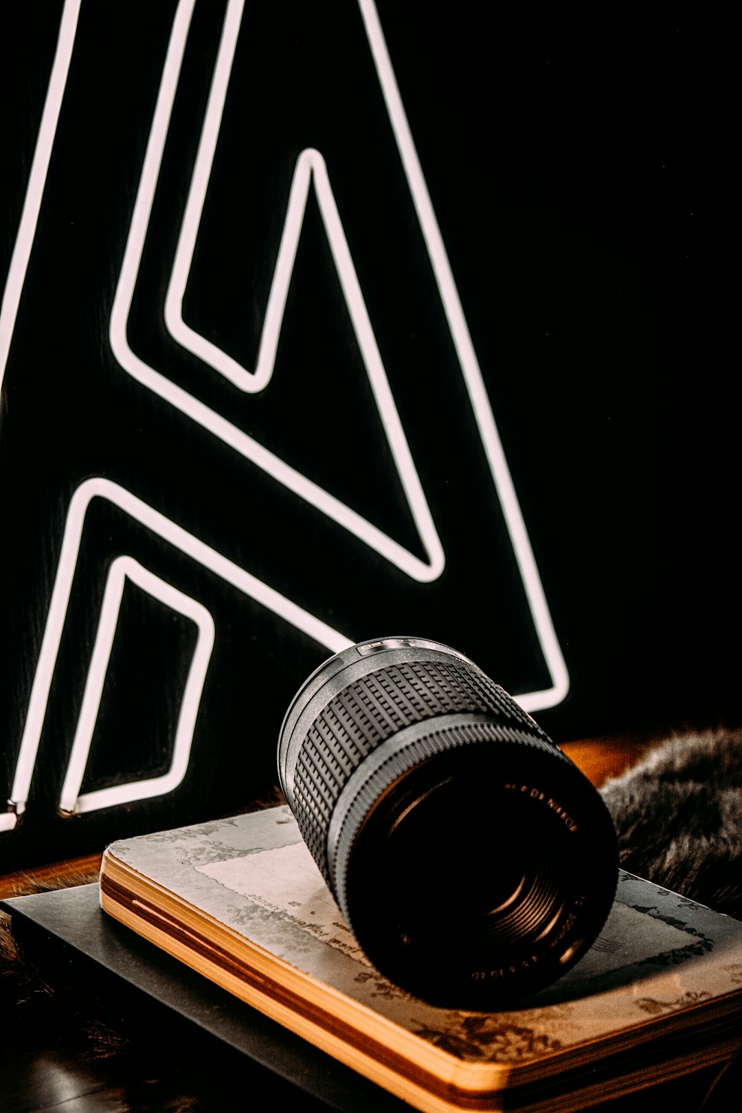 black camera lens on brown wooden table