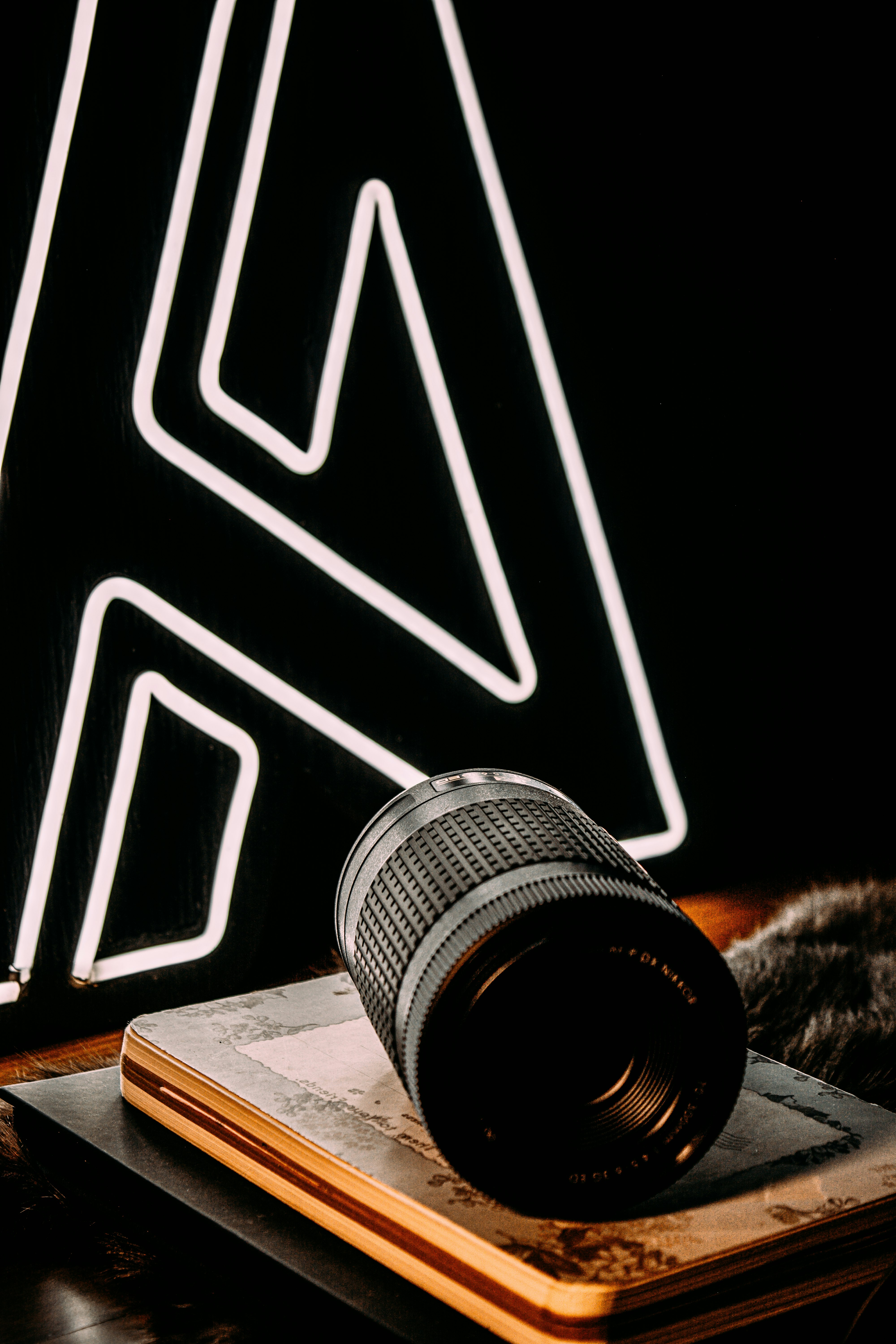 black camera lens on brown wooden table