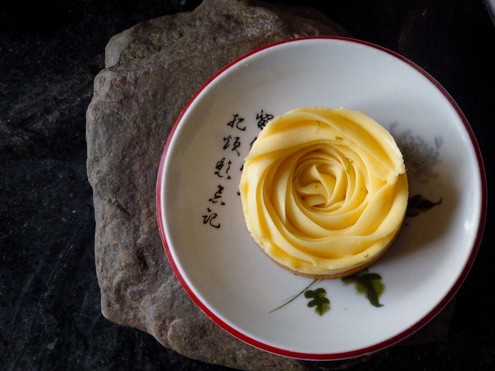 yellow rose on white ceramic plate