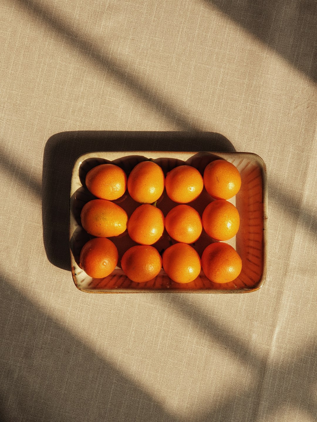 orange fruits in black tray