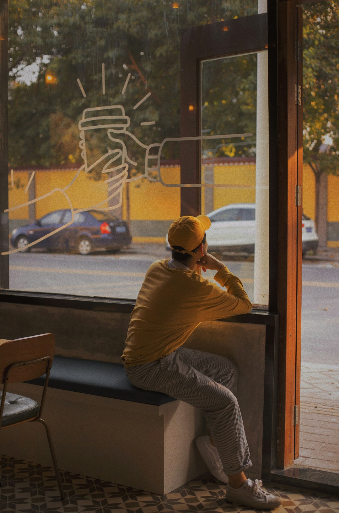 man in brown long sleeve shirt and brown hat sitting on chair