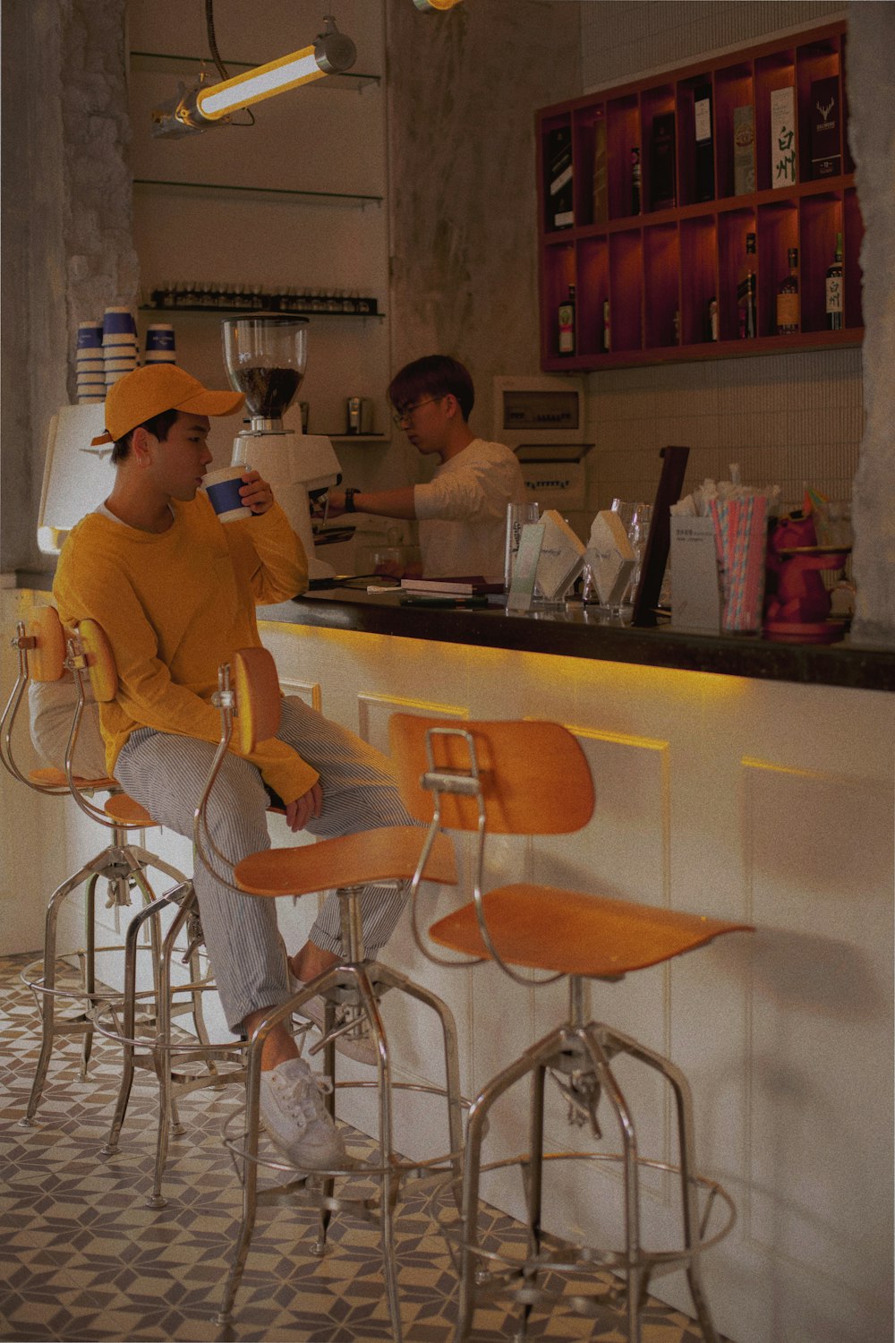 woman in yellow sweater sitting on chair