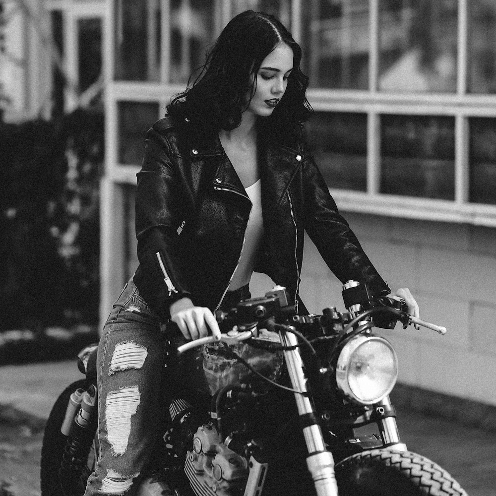 woman in black coat riding motorcycle