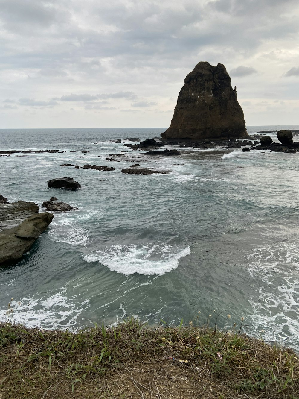 brown rock formation on sea during daytime