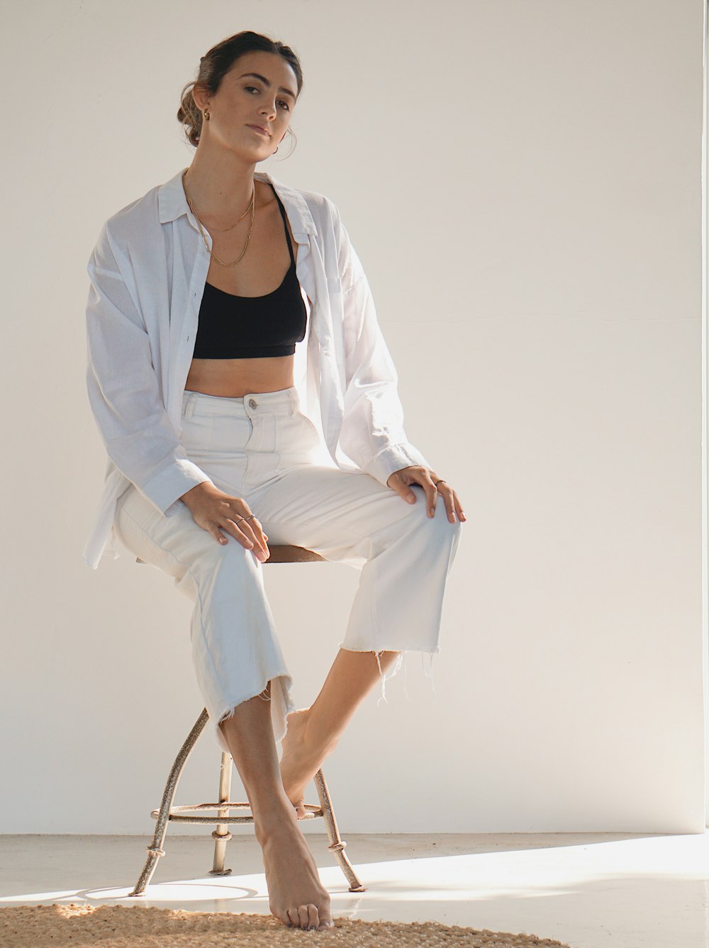 woman in white blazer and white dress shirt sitting on chair