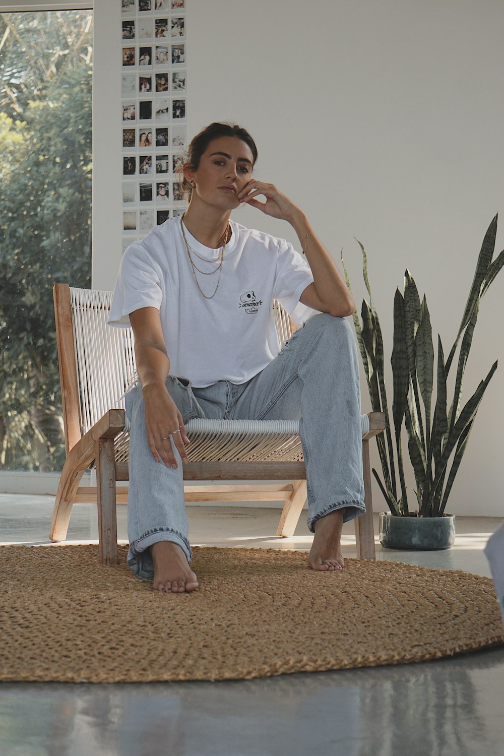 man in white crew neck t-shirt sitting on white wooden armchair