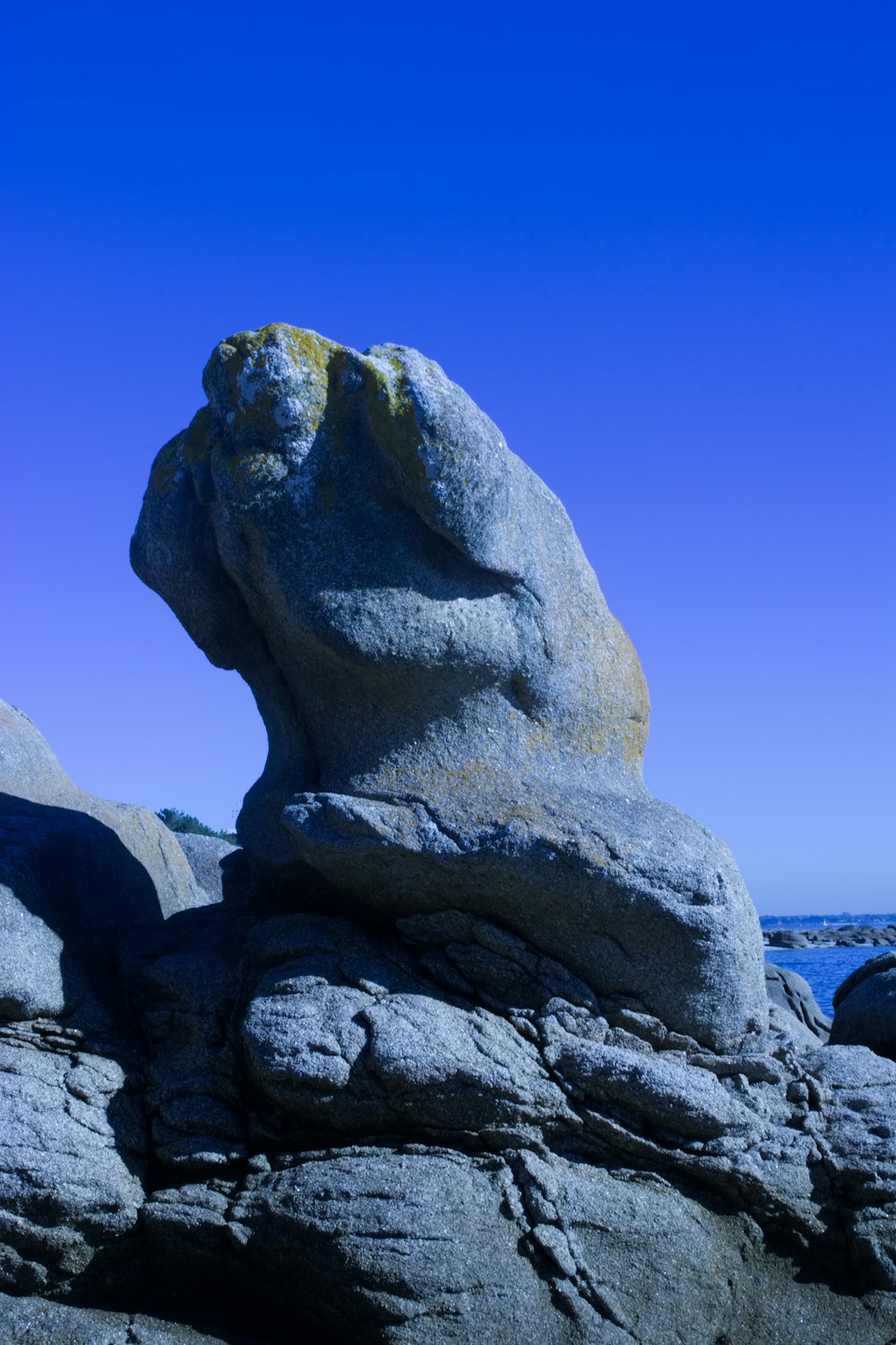 gray rock formation near body of water during daytime