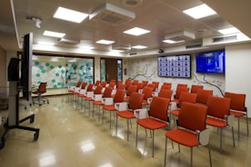 A sleek modern conference room with advanced videoconferencing equipment in use