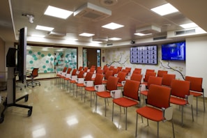 A modern conference room with a presentation screen displaying brand partnership opportunities.