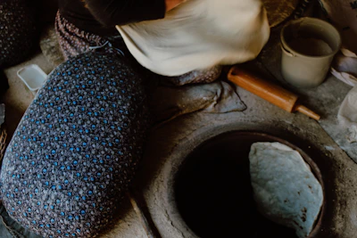 Chef carefully sealing a clay pot biryani with dough for slow cooking.