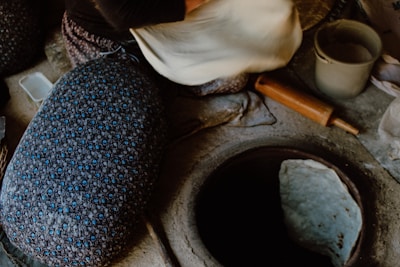 A warm kitchen scene showing hands preparing dough for fresh rotis.