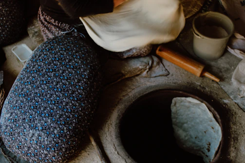 A serene kitchen scene with a customer preparing dough using tatvaveda’s stone-ground flour.