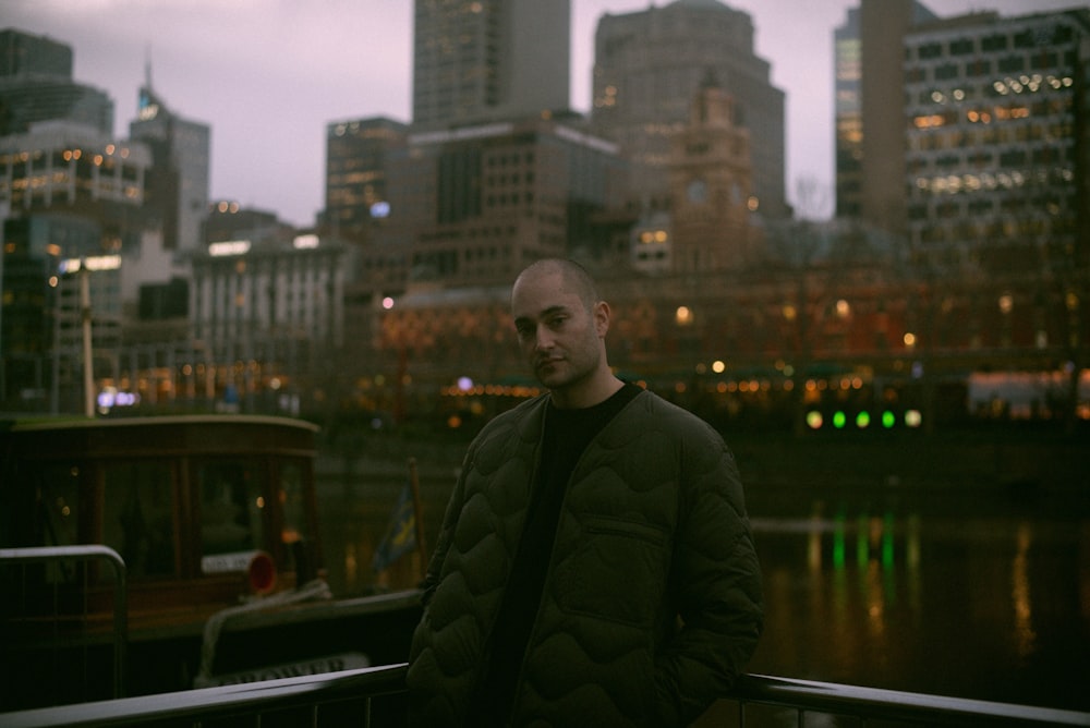 man in black jacket standing on top of building during daytime