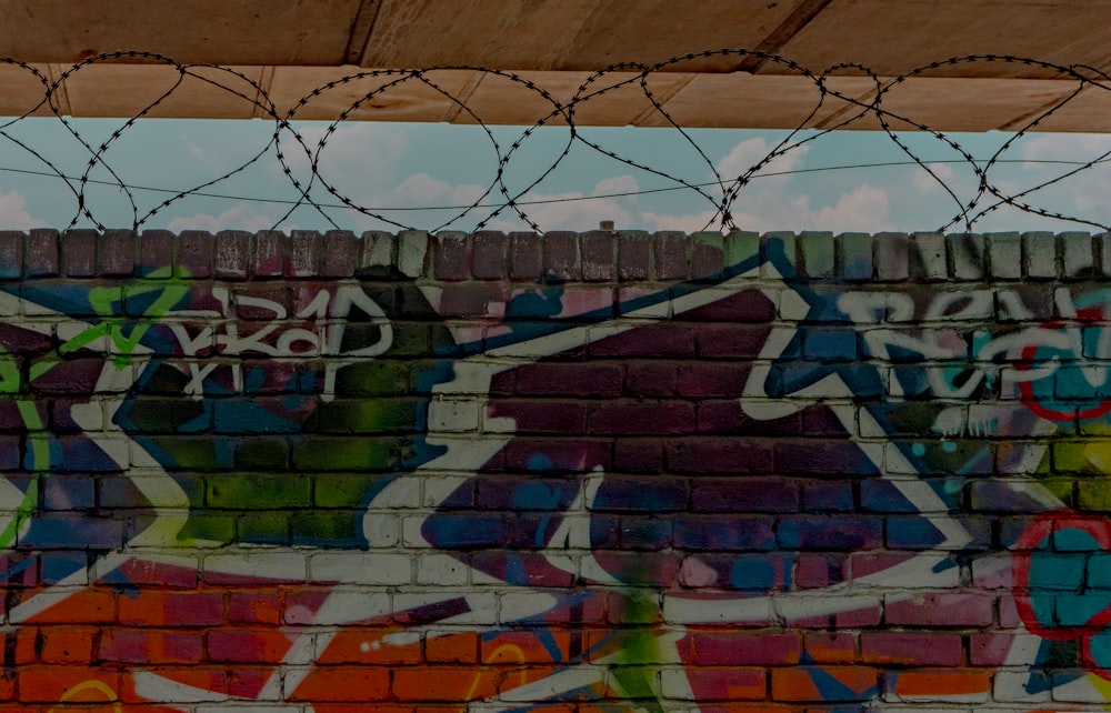 brown and green graffiti on wall