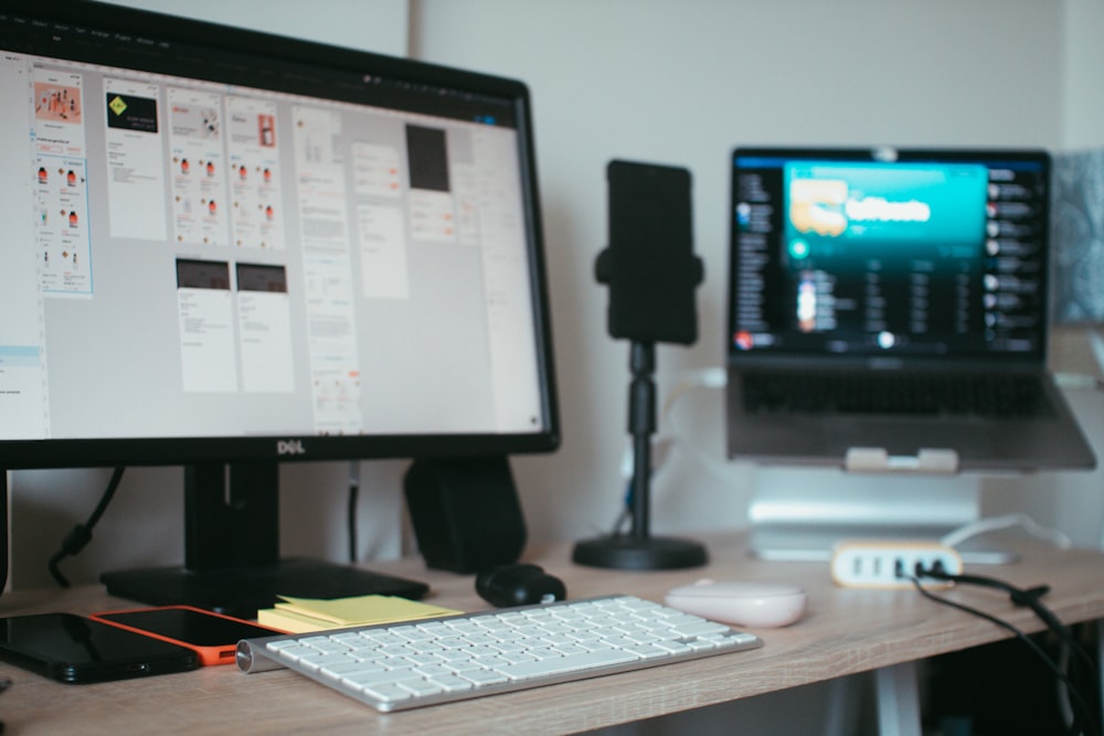 black flat screen computer monitor on brown wooden desk