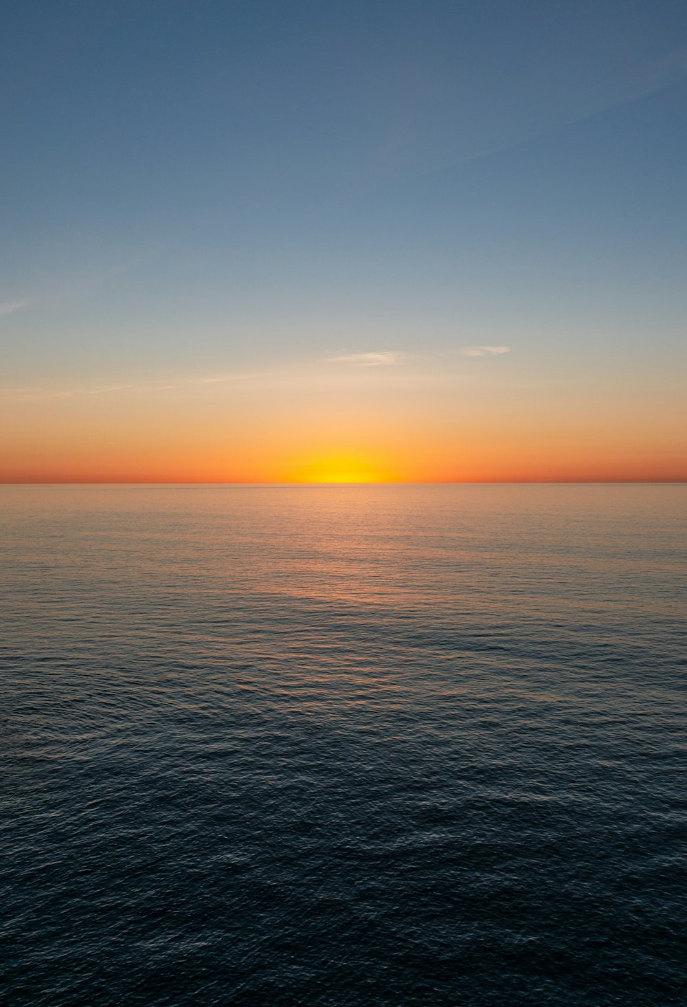 body of water during sunset