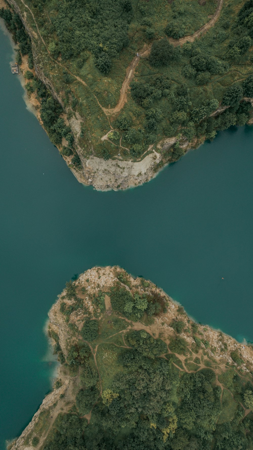 aerial view of green and brown mountain beside body of water during daytime