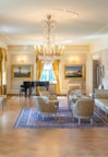 A luxurious suite with elegant furniture and a cozy seating area.