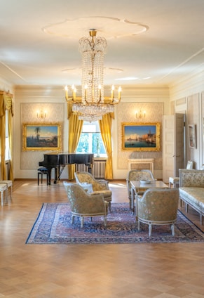 Beautiful living room with a piano and luxurious chairs looking spotless after Speckless cleaning