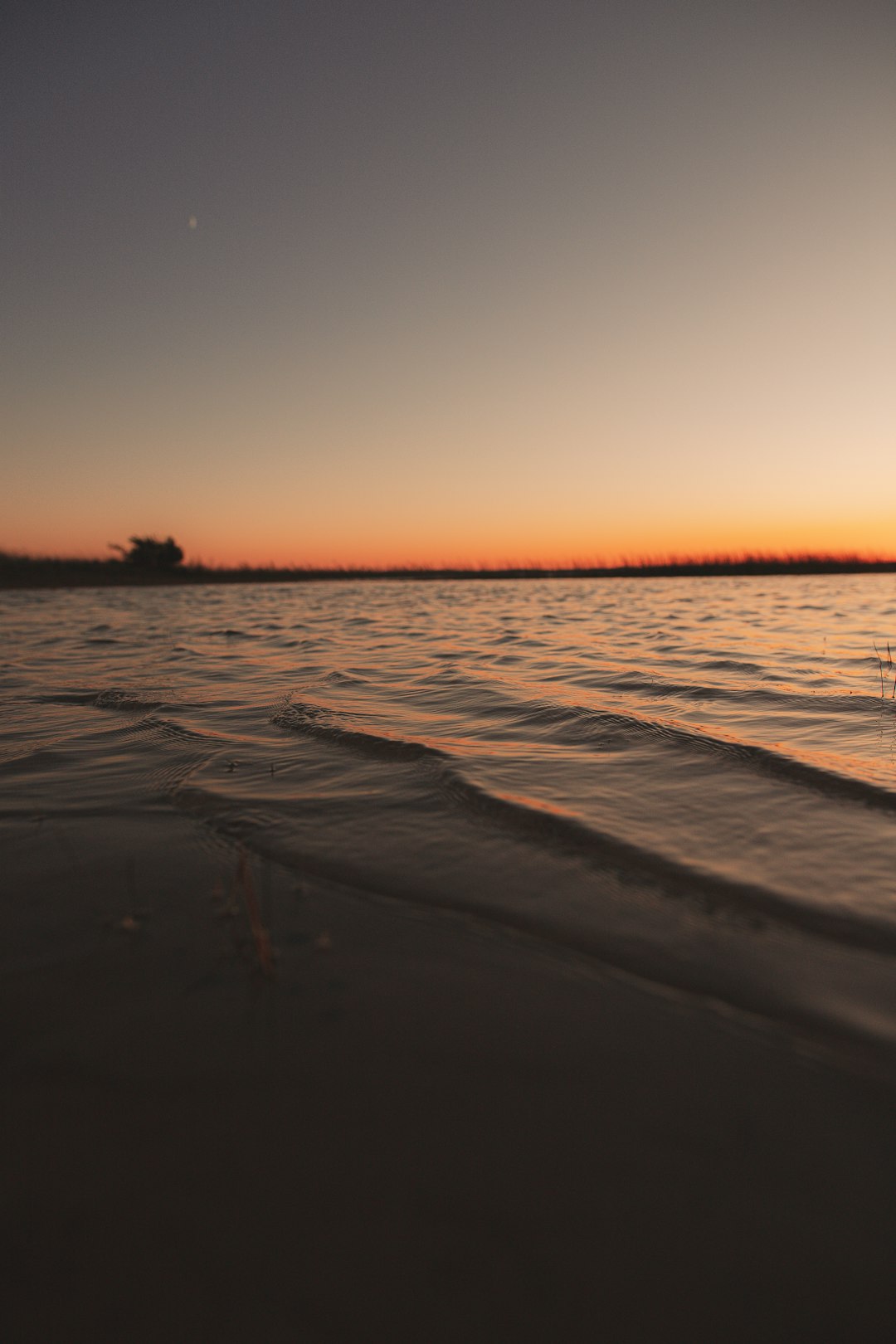 body of water during sunset