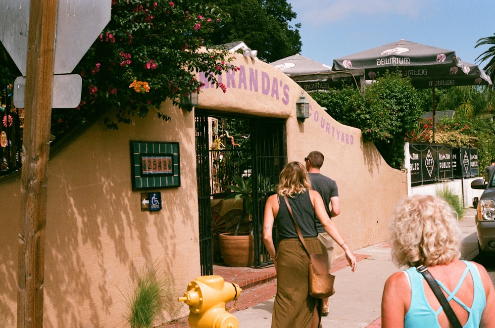 woman in black tank top and brown pants standing beside woman in black tank top