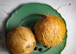 brown round fruit on green plastic container