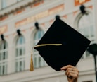 person holding black academic hat