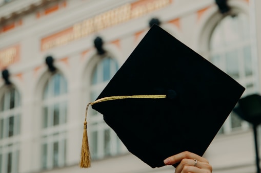 person holding black academic hat