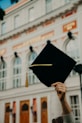 person holding black academic hat