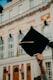 person holding black academic hat