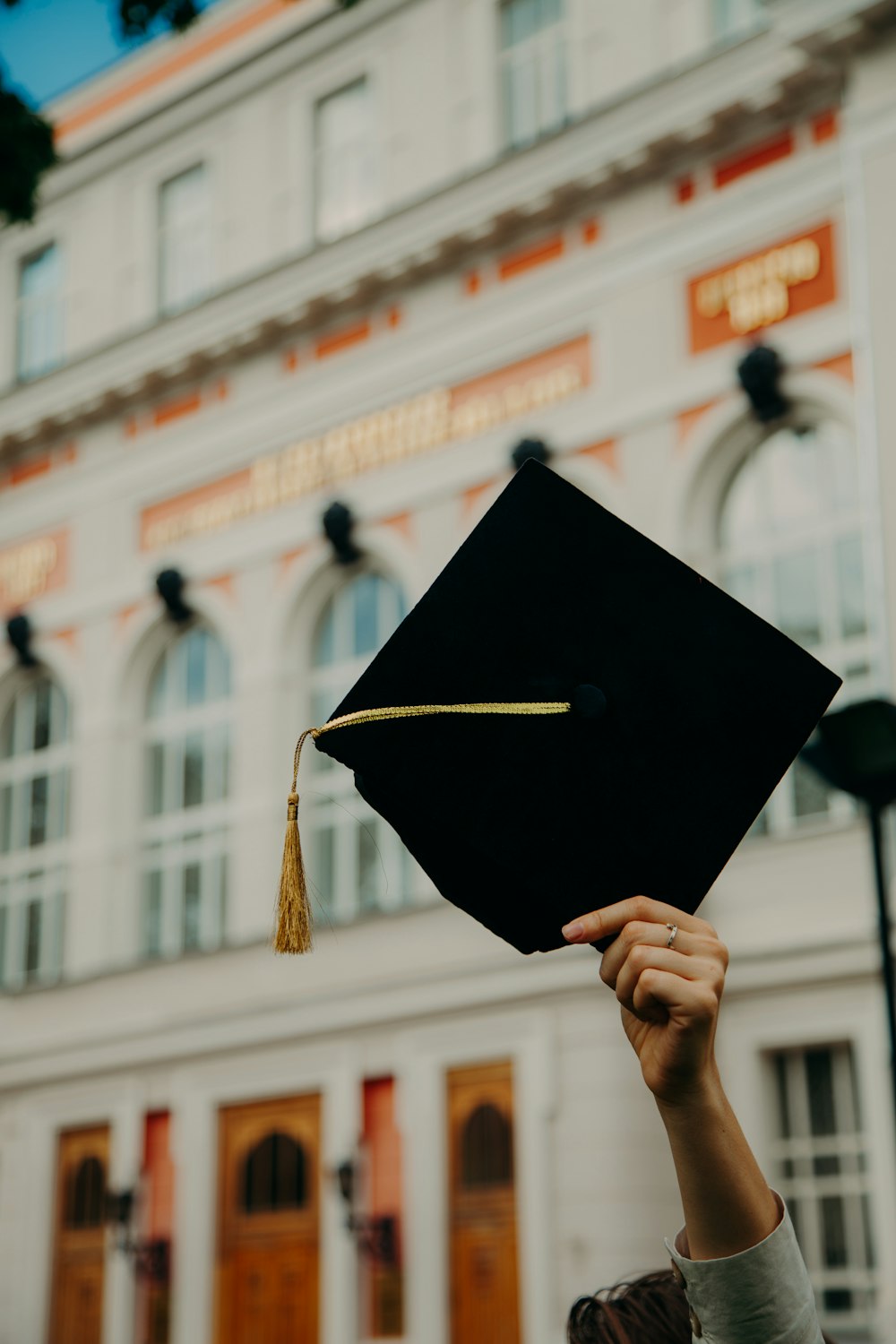 person holding black academic hat