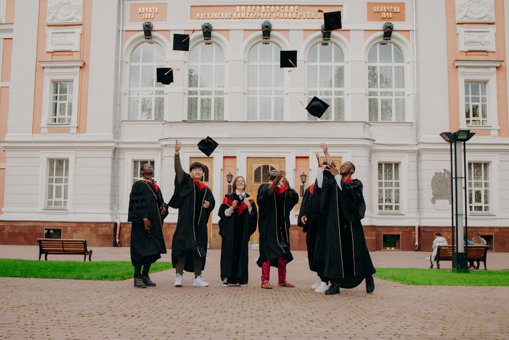 international students in black academic dress standing 