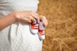person holding white and red plastic toy car