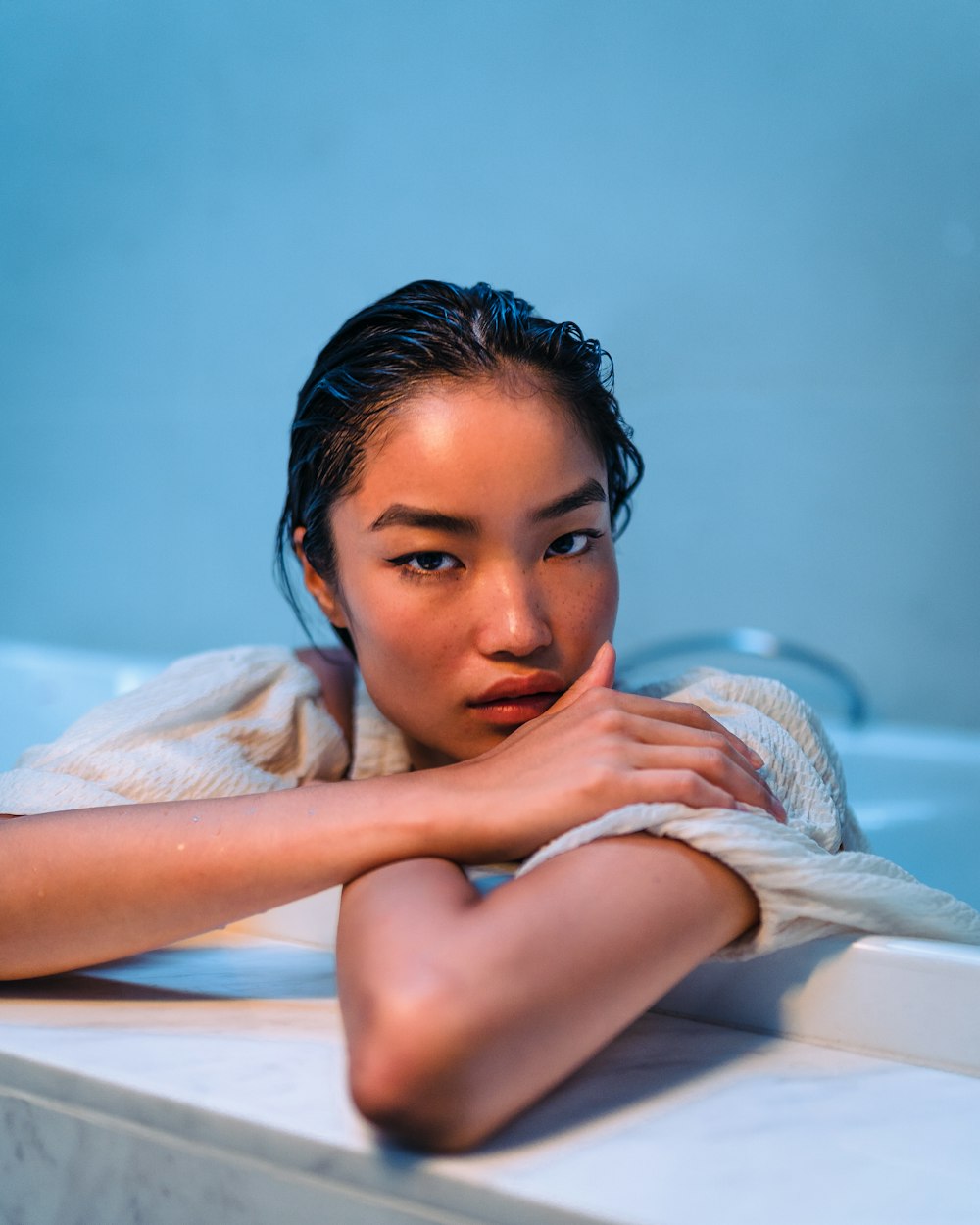 woman lying on white bed